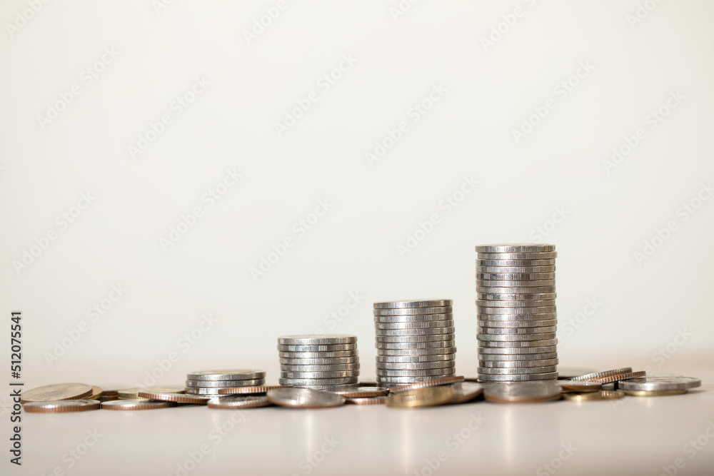 a pile of coins on a table with white background, with money stack step up growing growth saving money, Concept financial business investment, copy space a pile of coins on a table with white background, with money stack step up growing growth saving money, Concept financial business investment, copy space