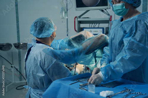 Woman with covered legs undergoing hysteroscopy in clinic photo