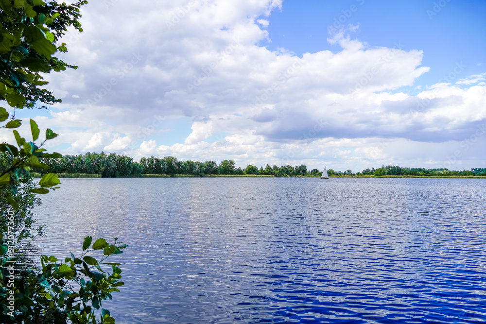 Obraz premium Ehrlichsee near Oberhausen-Rheinhausen. Lake with surrounding landscape in summer. 