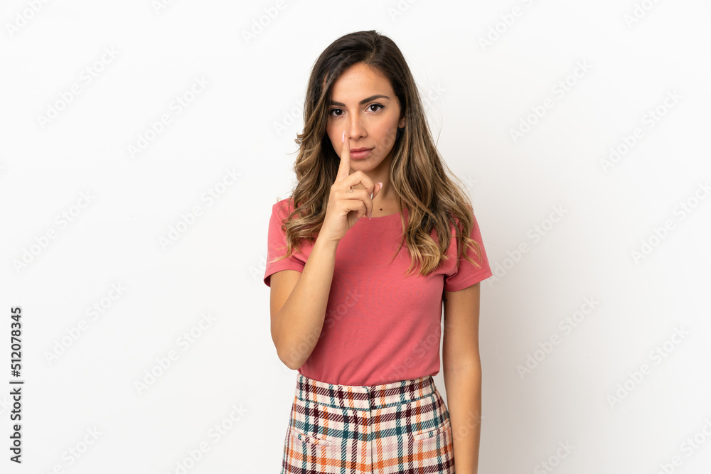 Young woman over isolated background showing a sign of silence gesture putting finger in mouth Young woman over isolated background showing a sign of silence gesture putting finger in mouth