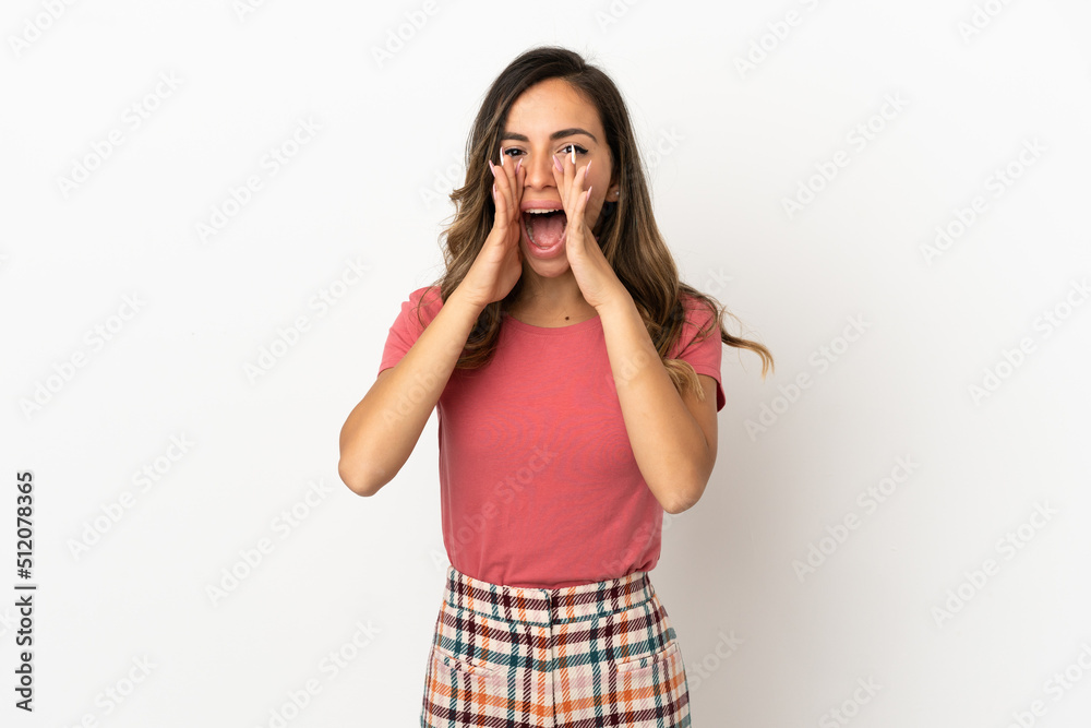 Young woman over isolated background shouting and announcing something Young woman over isolated background shouting and announcing something