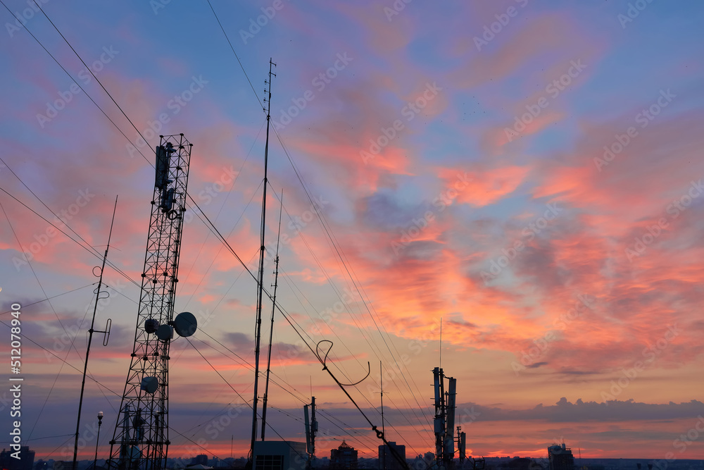 televisions antennas with sunset cloudy sky