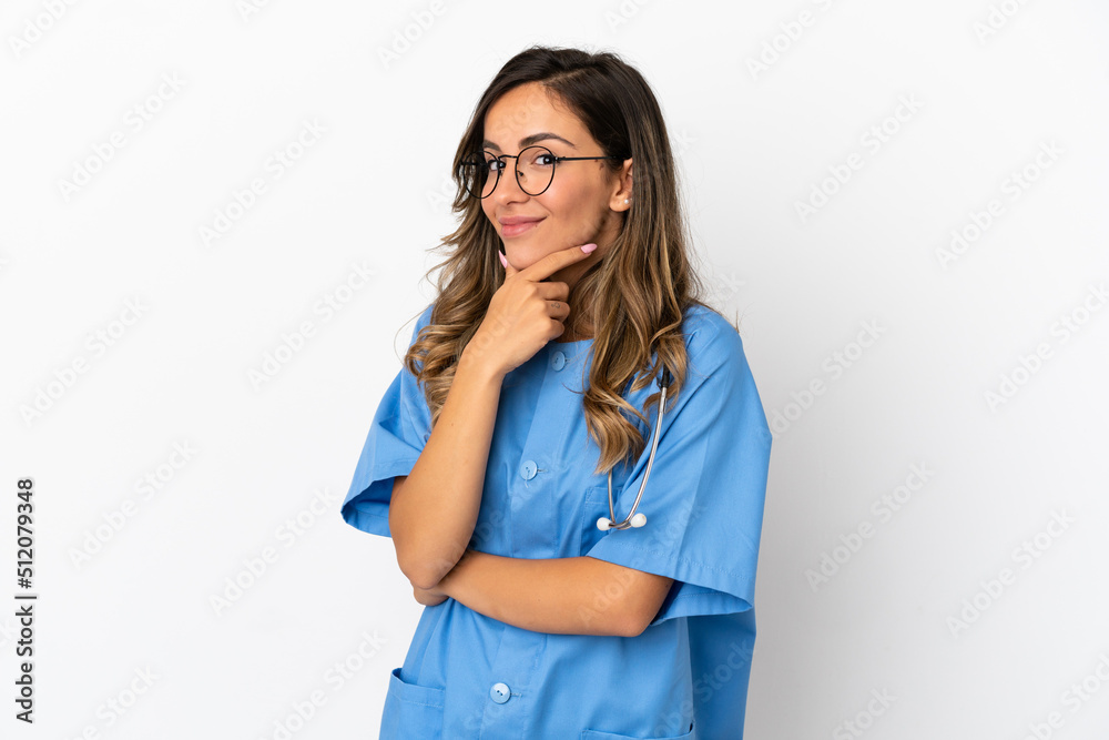 Young surgeon doctor woman over isolated white wall smiling Young surgeon doctor woman over isolated white wall smiling