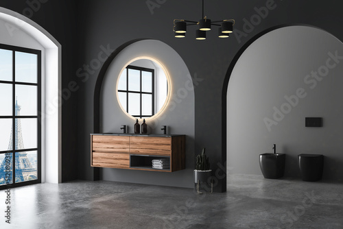 Dark bathroom interior with concrete floor, arches, black toilet and oval mirror, front view. Minimalist black bathroom with modern furniture. 3d rendering 