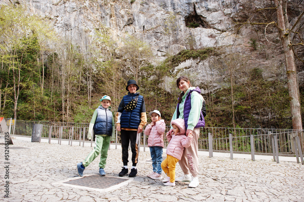 Family explores at Punkva Caves outdoor near rocks, Czech Republic.