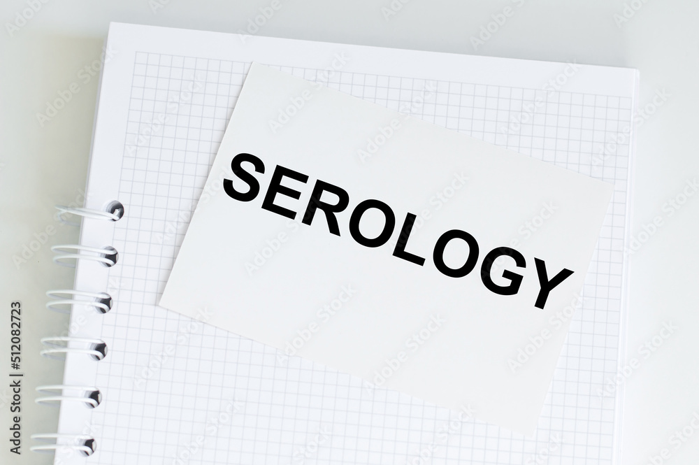 Serology text card on a notebook that sits on a light desk, a medical concept