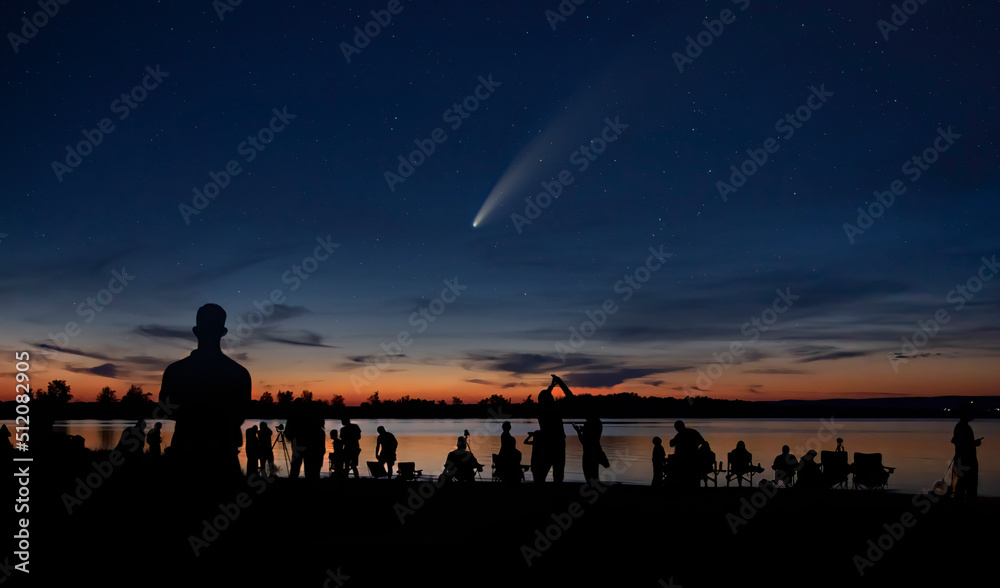 Comet Neowise and crowd of people silhouetted by the Ottawa river watching and photographing the comet
