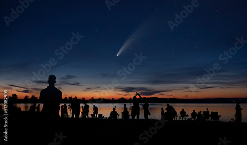 Comet Neowise and crowd of people silhouetted by the Ottawa river watching and photographing the comet photo