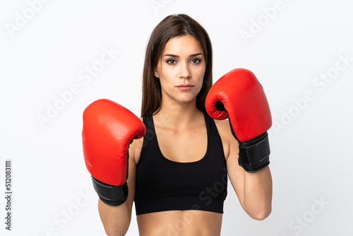Young sport woman isolated on white background with boxing gloves © luismolinero