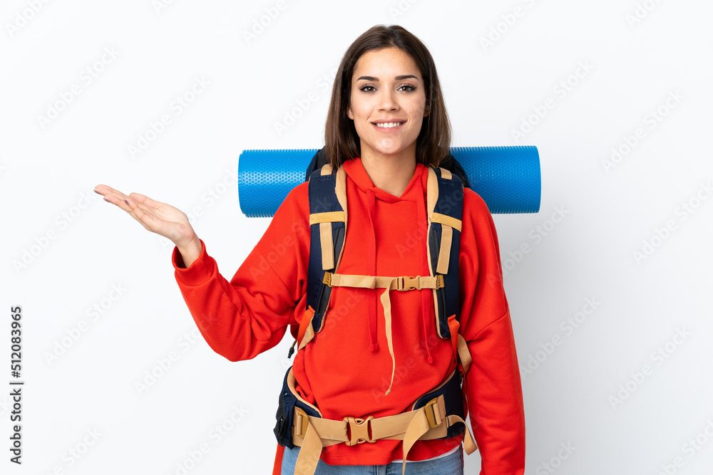 Young caucasian mountaineer girl with a big backpack isolated on white background holding copyspace imaginary on the palm Young caucasian mountaineer girl with a big backpack isolated on white background holding copyspace imaginary on the palm