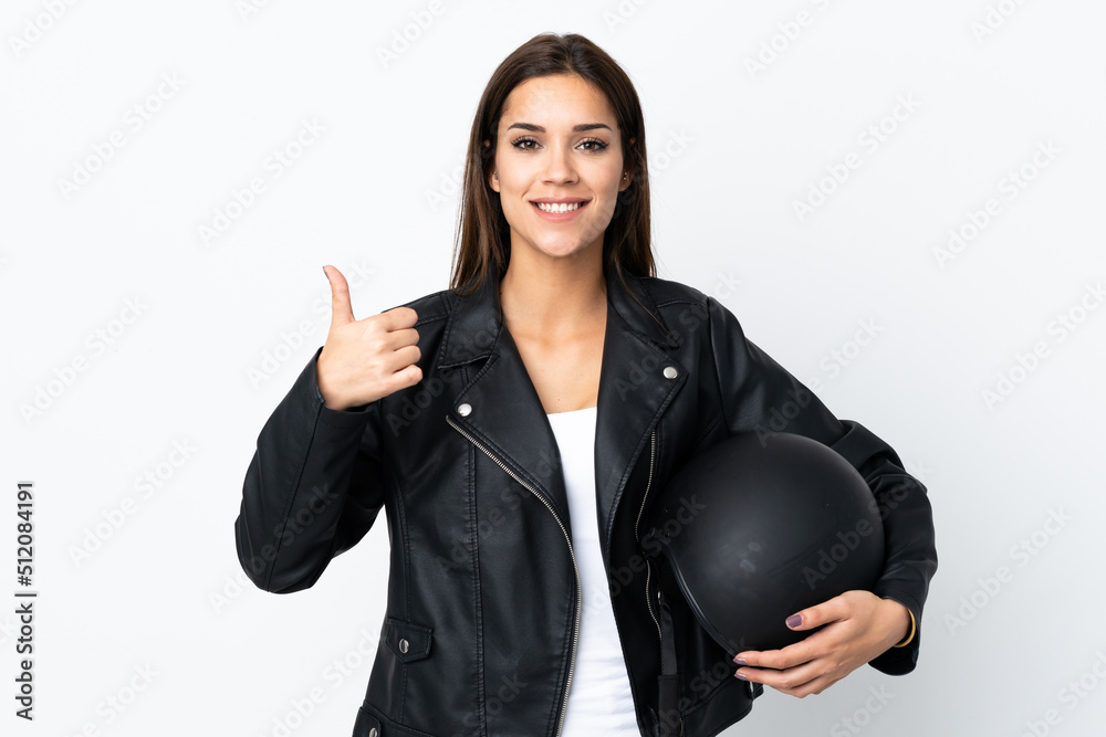 Caucasian girl holding a motorcycle helmet on white background giving a thumbs up gesture Caucasian girl holding a motorcycle helmet on white background giving a thumbs up gesture