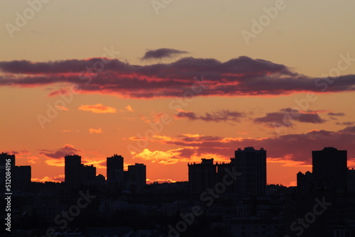 Urban landscape on the background of sunset. Orange sunset.  Silhouette of the city