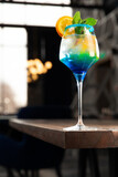 Layered alcoholic cocktail with blue liqueur.