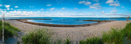 Panoramic curved beach seascape at the seabird animal wildlife sanctuary on Cape Cod with dramatic cloudscape over Martha s Vineyard in the Atlantic Ocean.