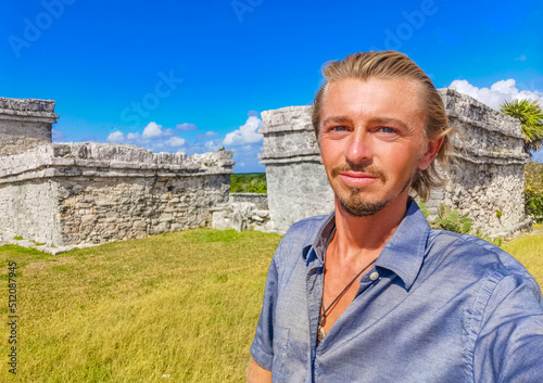 Tourist guide at ancient Tulum ruins Mayan site pyramids Mexico. © arkadijschell