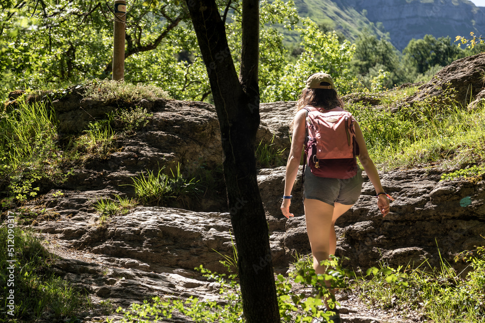 woman trekking in shorts through the woods of the Basque Country woman trekking in shorts through the woods of the Basque Country