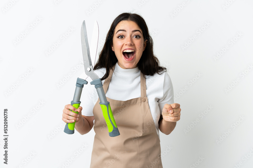 Young caucasian woman holding a plant isolated on white background celebrating a victory in winner position Young caucasian woman holding a plant isolated on white background celebrating a victory in winner position