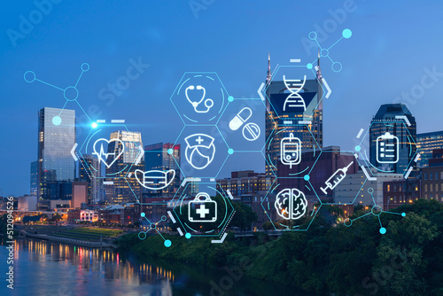 Panoramic view of Broadway district of Nashville over Cumberland River at illuminated night skyline, Tennessee, USA. Hologram healthcare digital medicine icons. The concept of treatment from disease