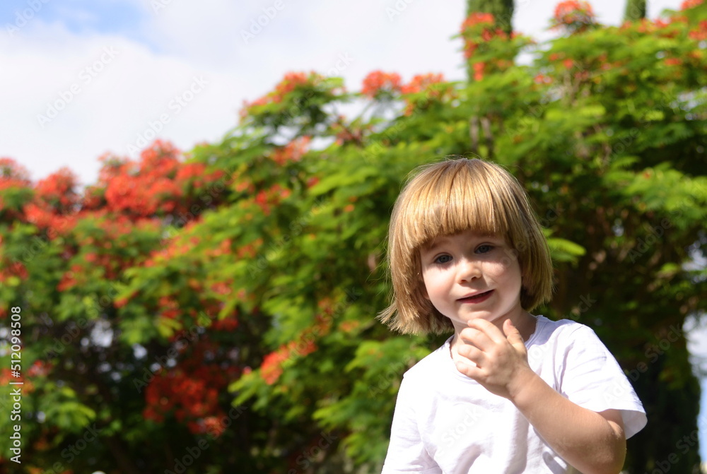 Cute little boy. A three-year-old child is a portrait in nature, in gardens, a tree in bloom. Space for text, positive kid smiling on a sunny summer day Cute little boy. A three-year-old child is a portrait in nature, in gardens, a tree in bloom. Space for text, positive kid smiling on a sunny summer day