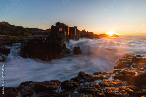 Sunrise view with breaking wave at Bombo Quarry, Australia.