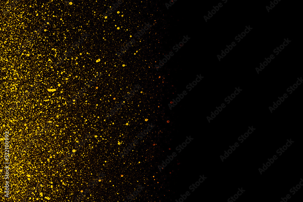Golden color shiny paint particles on black background	

