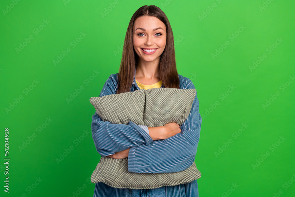 Fototapeta premium Photo of adorable lovely satisfied girl hands hold pillow toothy beaming smile isolated on green color background
