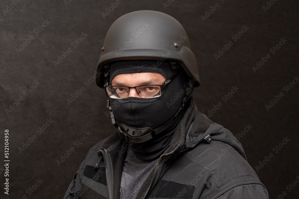 Portrait of a military man with glasses, wearing a bulletproof vest and