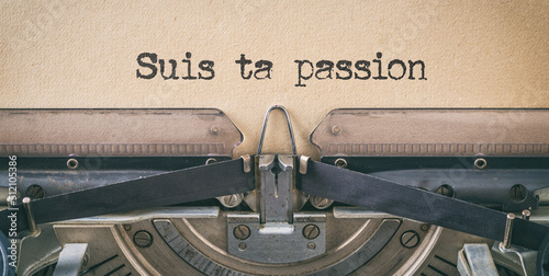 Text written with a vintage typewriter - Follow your passion in french - Suis ta passion