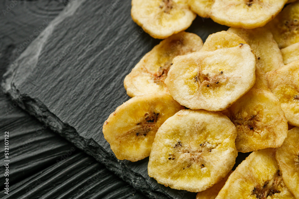 delicious dried banana on a black wooden rustic background