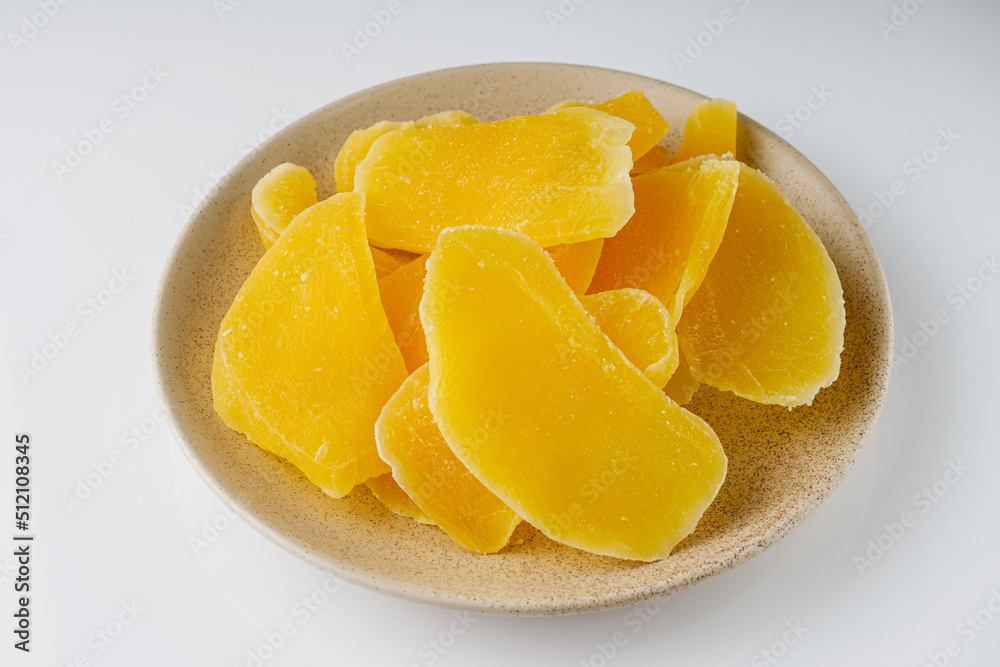 delicious dried mango on a white acrylic background delicious dried mango on a white acrylic background