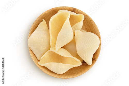 Conchiglioni italian pasta in wooden bowl isolated on white background. Top view. Flat lay