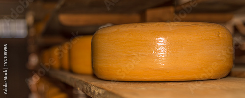 Enkhuizen, Netherlands, June 2022. Close up of a cheese warehouse. The cheeses are stacked on the shelf. photo