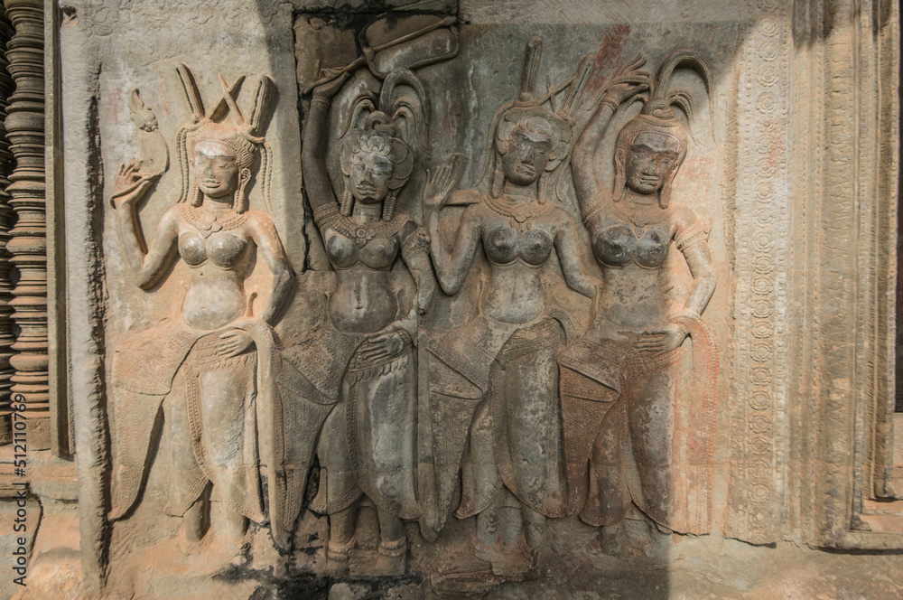 Sandstone carvings of four Apsaras in different postures in Angkor Wat Siem Reap, Cambodia.