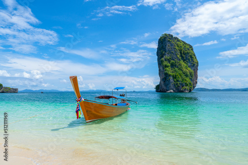 Thai traditional wooden longtail boat and beautiful sand beach in Krabi province. Koh Poda island, Thailand.