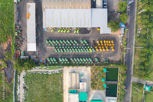 Aerial view of trash garbage tractor truck cars in industrial factory in environmental pollution. Waste disposal in dumping site. © tampatra