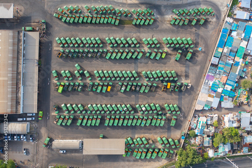 Aerial view of trash garbage tractor truck cars in industrial factory in environmental pollution. Waste disposal in dumping site.