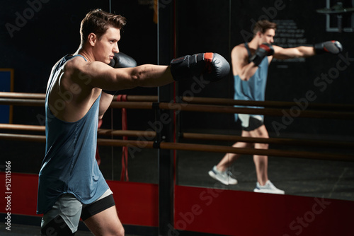 Fototapeta Naklejka Na Ścianę i Meble -  Muscular young man working out at gym