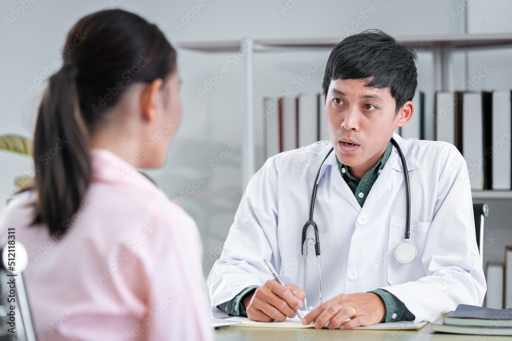 Asian male doctor talking to a patient to maintain the health of the patient Providing health advice to patients at the hospital