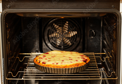 Closeup homemade berry pie baked in a home oven. Shallow focus.