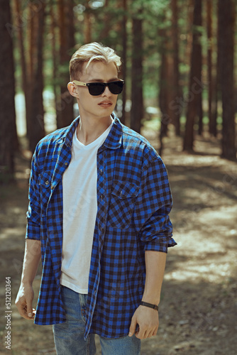 guy walking in pine forest