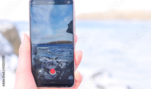 Smartphone in the hand winter mobile shooting . High quality photo photo