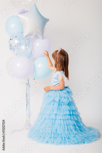 Little girl with blue balloons