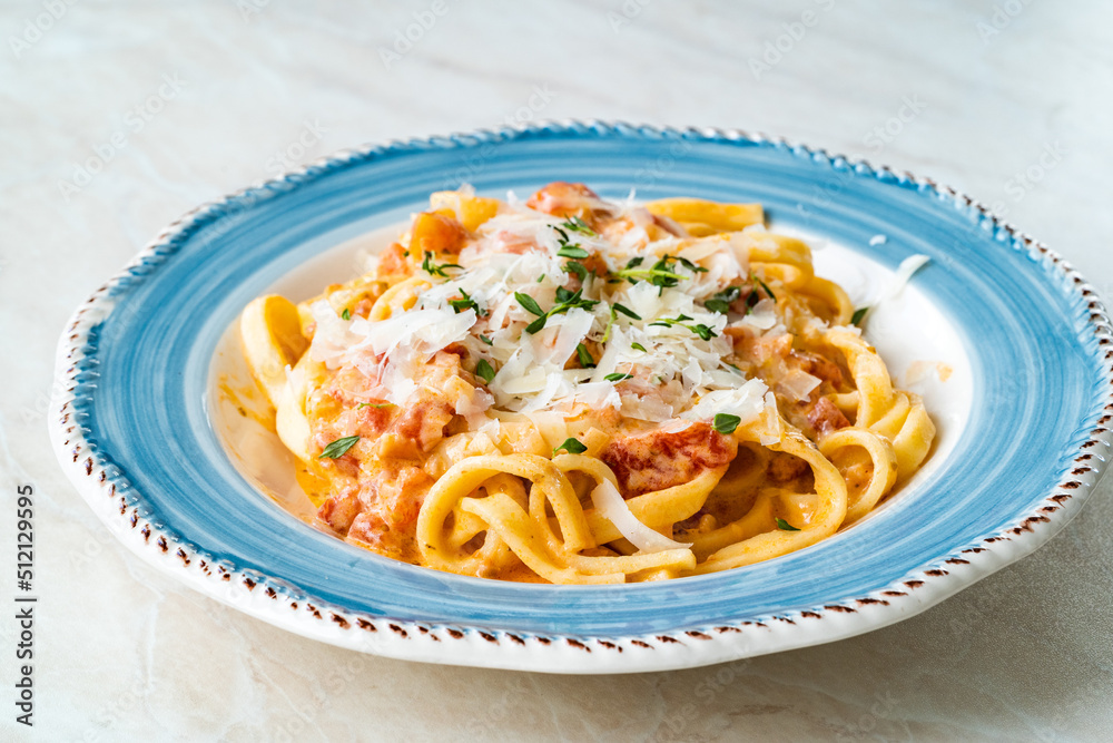 Homemade Tagliatelle Pasta with Tomato Cream Sauce and Parmesan Cheese.