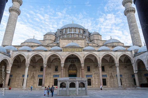 Suleiman Mosque seen from the inner courtyard, with its ablution fountain. At sunset with a blue sky, with white broken clouds.