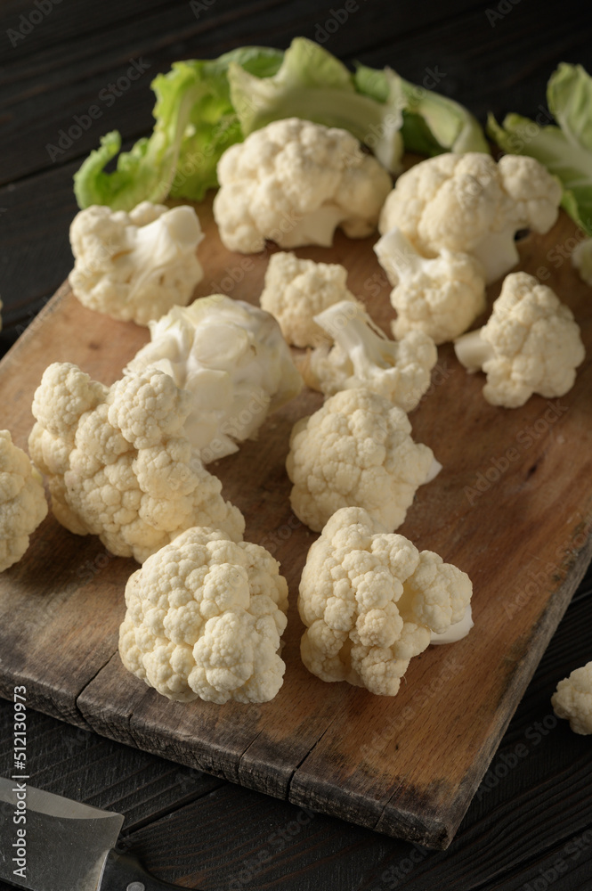 Raw, fresh organic cauliflower on a wooden background. Healthy eating, low carb diet concept Raw, fresh organic cauliflower on a wooden background. Healthy eating, low carb diet concept