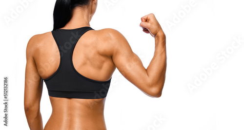 Athletic young woman showing muscles of the back and hands-on an isolated white background