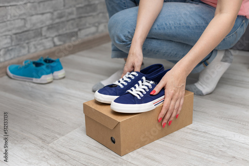 girl holding a box with new sneakers