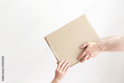 cardboard box in hand. give a box with delivery