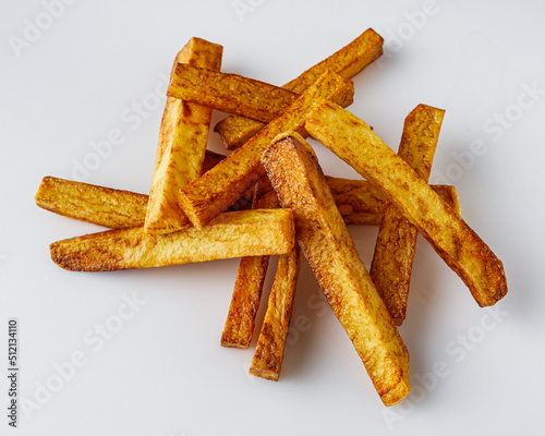 golden french fries on a white acrylic background