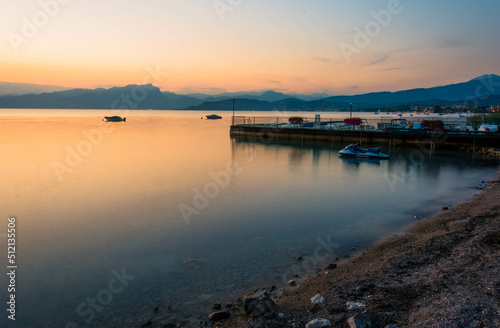 Coast of Garda Lake at the evening during sunset photo